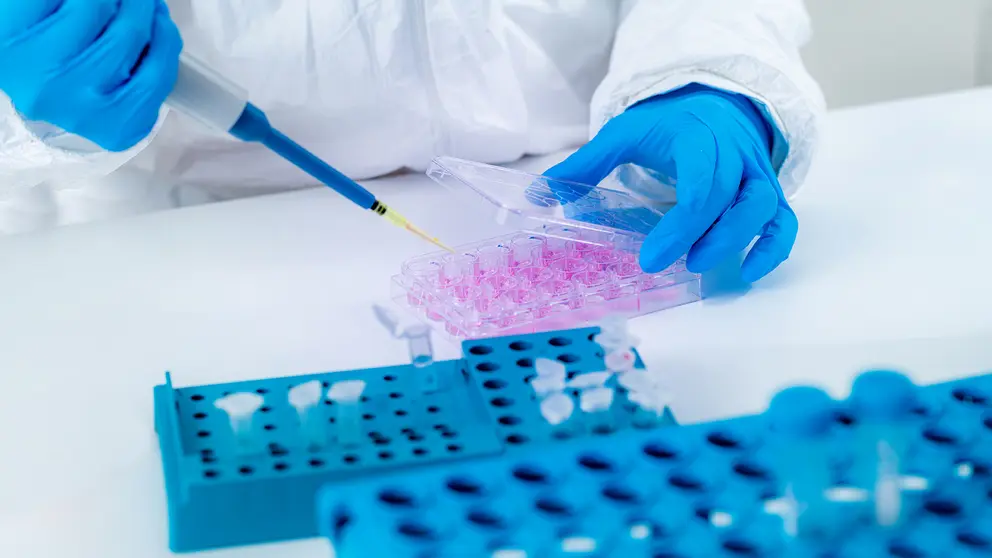 Coronavirus Vaccine Research. Scientist in Protective Suit Researching Virus Antibodies, Developing a Vaccine