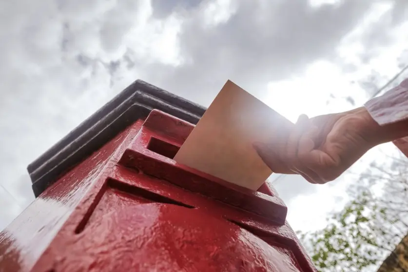 closeup-on-a-male-hand-putting-a-letter-in-a-red-l-2022-05-24-08-12-33-utc (1)