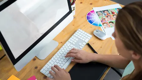 Woman working on desktop pc in office
