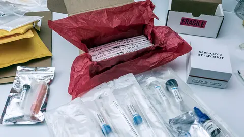 Boxes with Covid-19 PCR kit in hospital warehouse, conceptual image