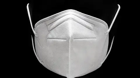 KN95 or FFP2 Face mask isolated on black background. Protection against Coronavirus Covid-19. Front view