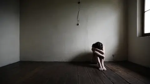 sad woman sitting alone in a empty room