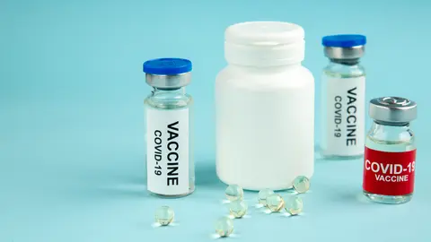 front view covid vaccines with pills on blue background hospital pandemic covid- virus cure drug