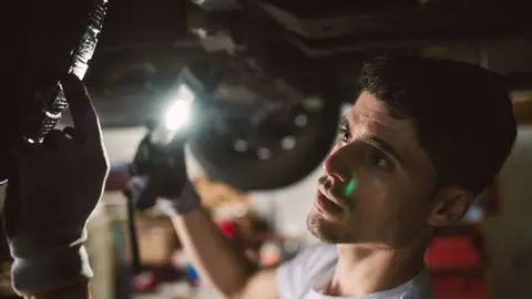 mechanic-checking-the-underbody-of-a-car-in-a-work-2022-03-08-01-30-16-utc