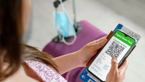 top-view-of-woman-holding-id-documents-and-covid-v-2022-12-22-23-44-54-utc (1)