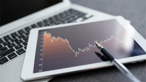 stock-market-analyze-with-digital-tablet-2023-11-27-05-34-18-utc (1)