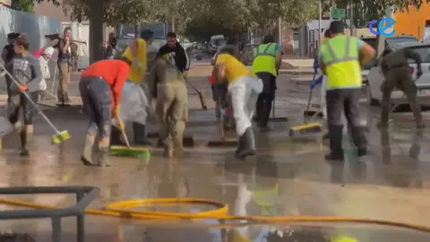 gente de ceuta en valencia quitando barro con escobas